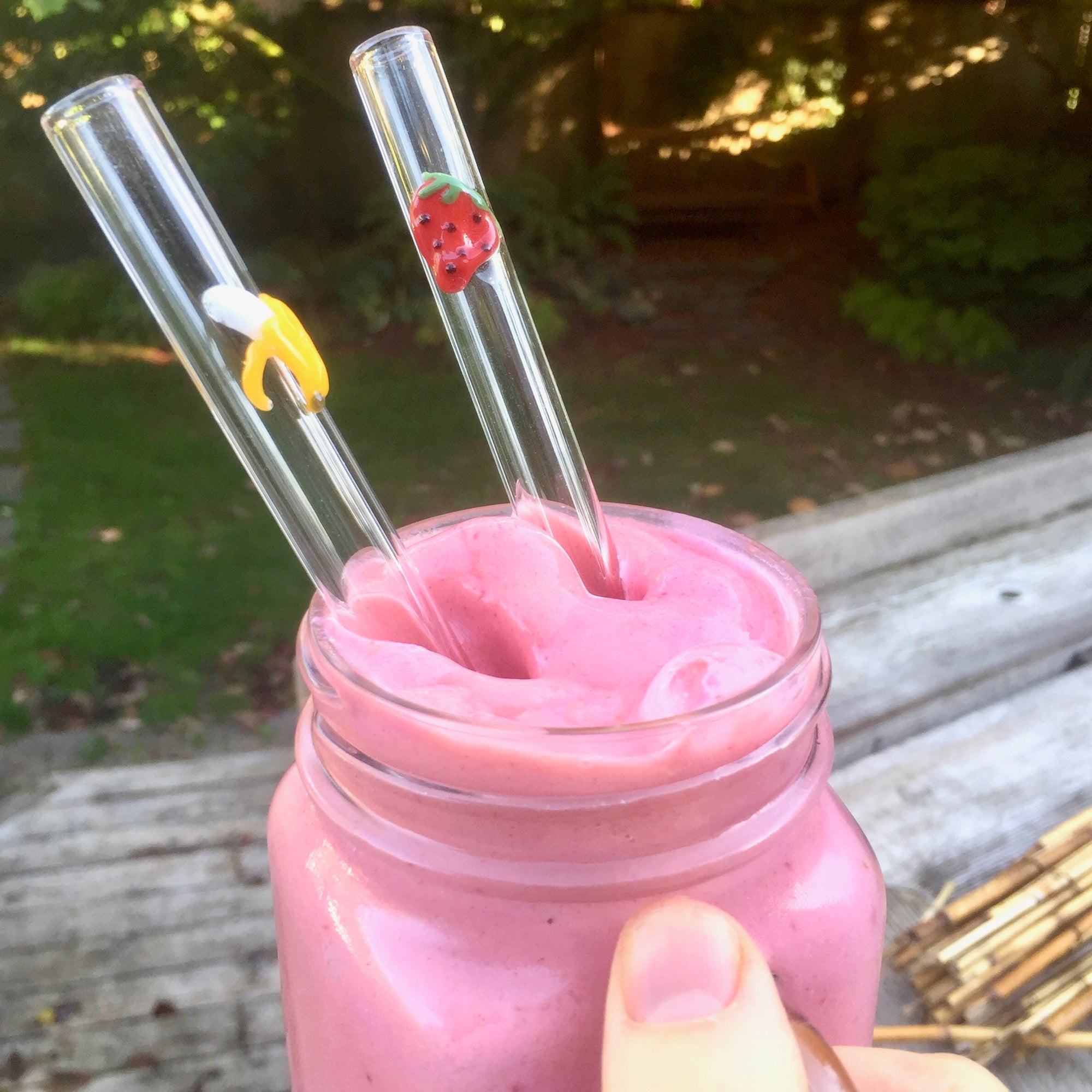 strawberry banana smoothie with strawberry banana glass straws